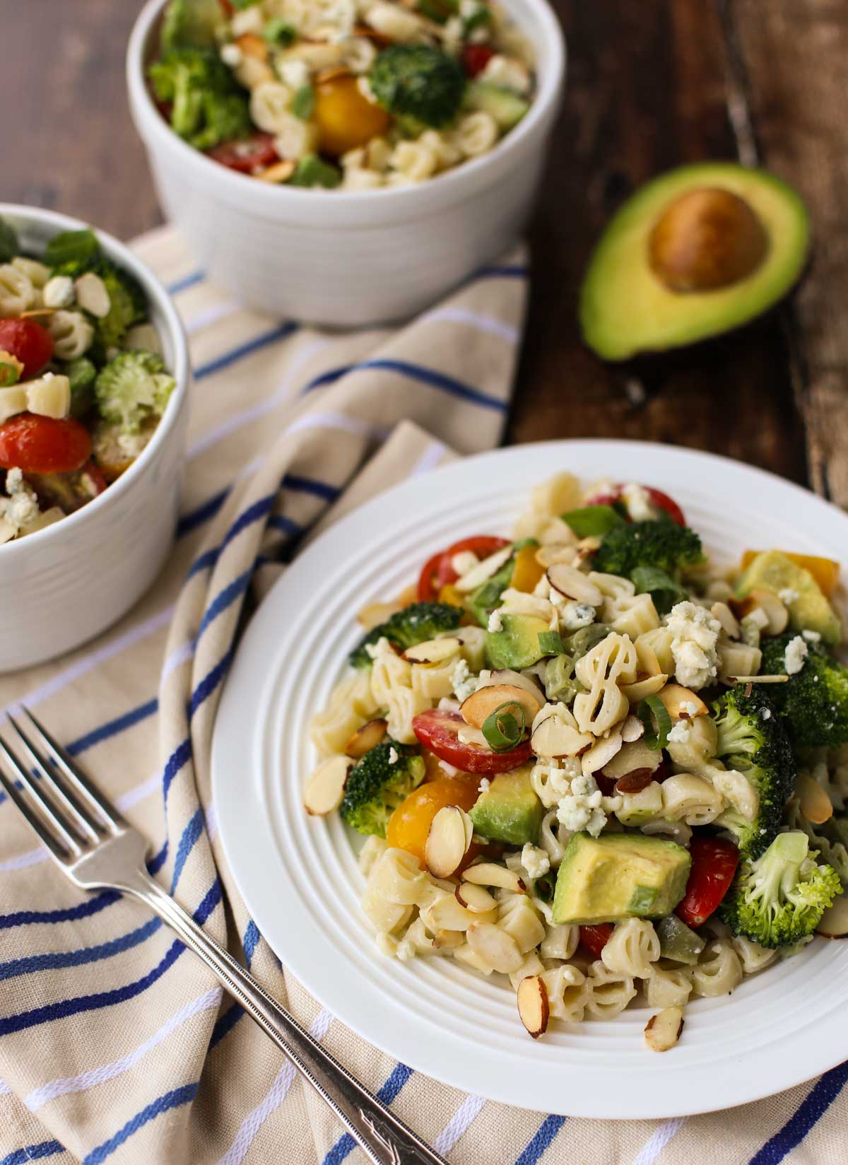 Blue Cheese Pasta Salad | Your favorite blue cheese veggies like cherry tomatoes and crunchy broccoli with toasted almonds and avocado! All tossed in a yummy blue cheese vinaigrette. Substitute feta for a lighter taste. Yum! | WorldofPastabilities.com