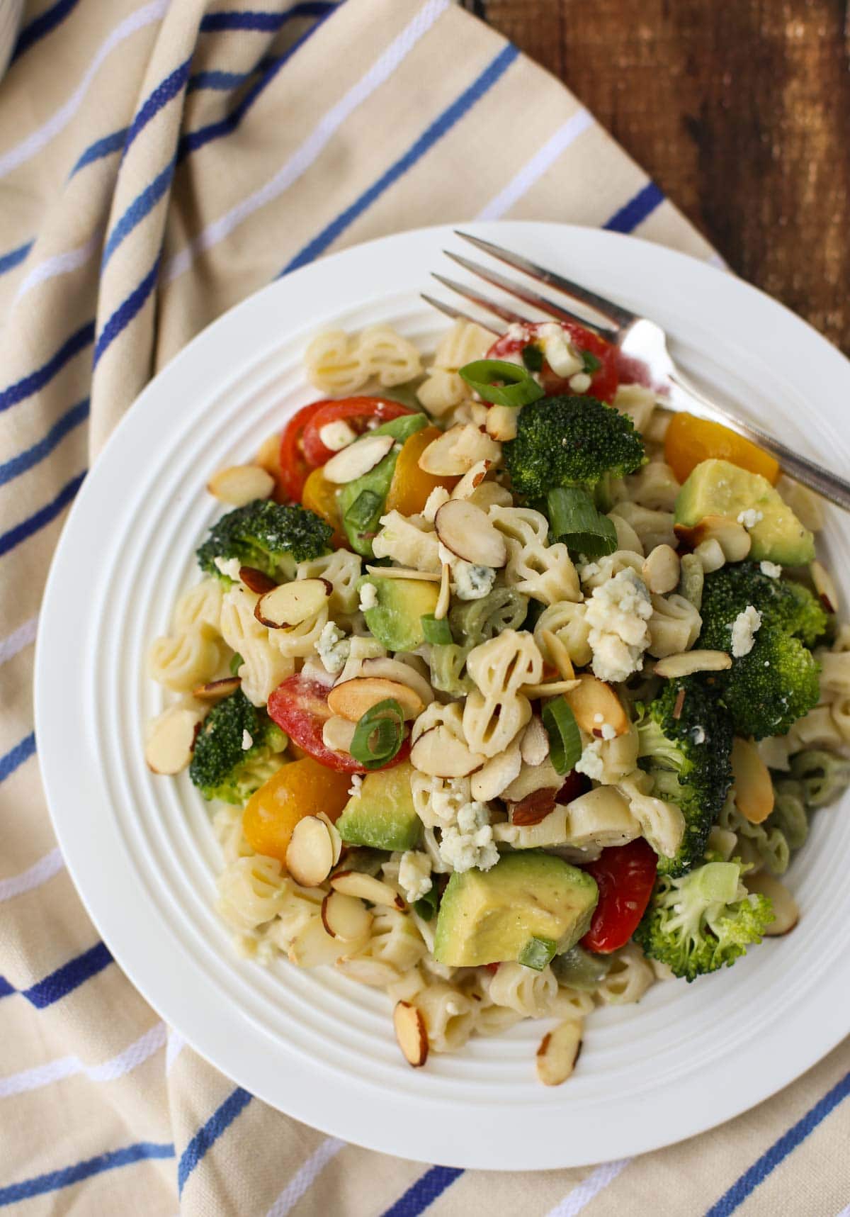 Blue Cheese Pasta Salad | Your favorite blue cheese veggies like cherry tomatoes and crunchy broccoli with toasted almonds and avocado! All tossed in a yummy blue cheese vinaigrette. Substitute feta for a lighter taste. Yum! | WorldofPastabilities.com