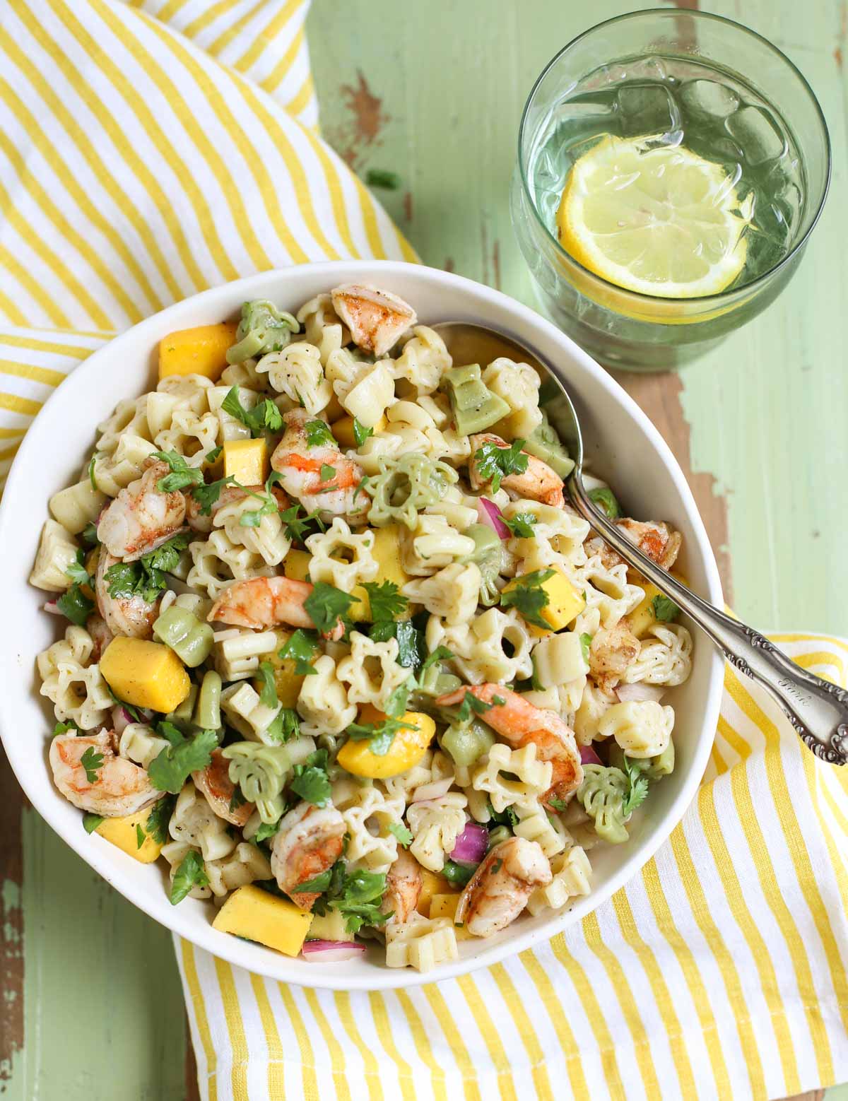 Overhead shot of Caribbean Pasta Salad with Glass of Lemon Water