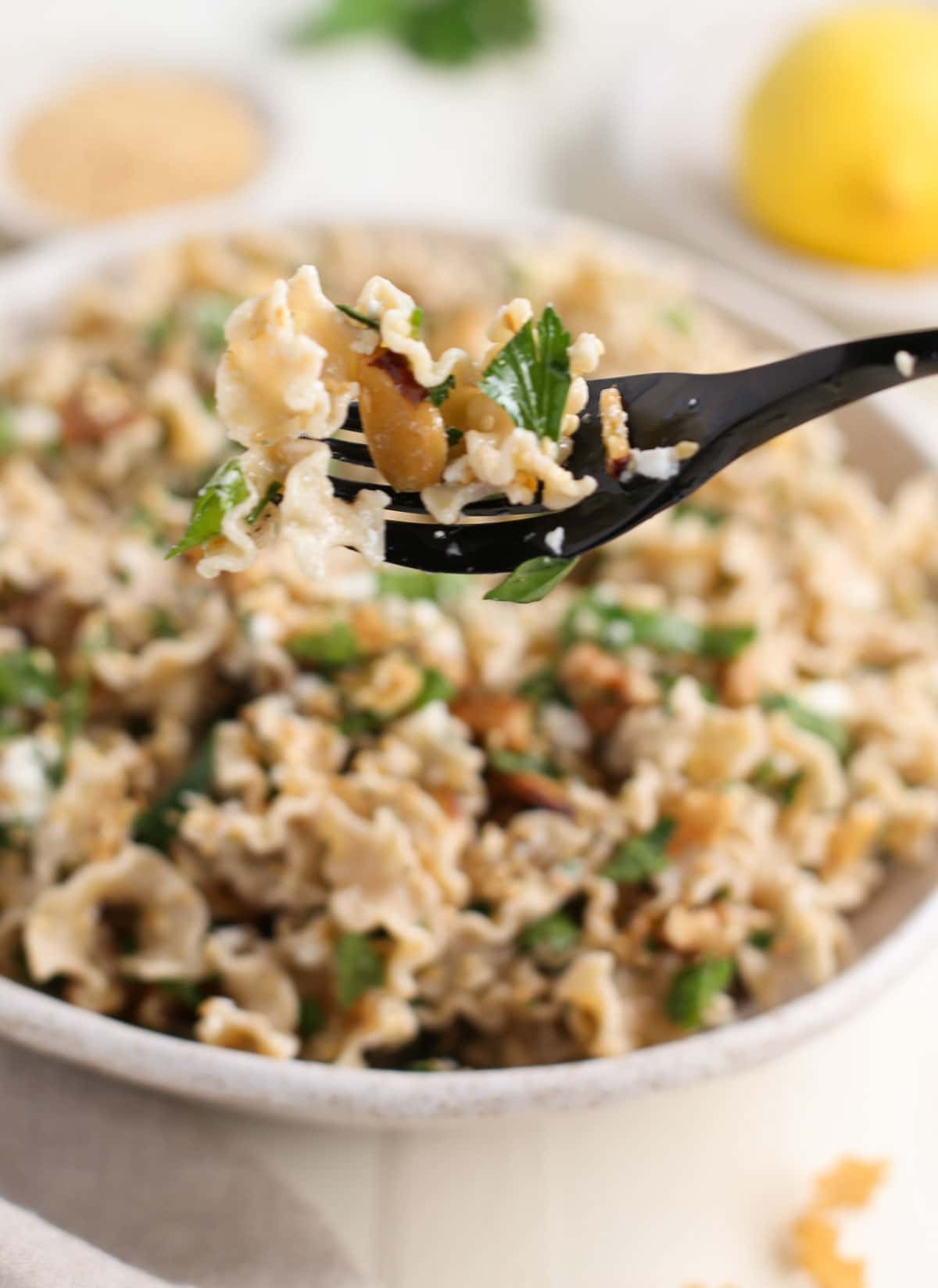 One forkful of Good Day Pasta with Toasted Nuts and Feta