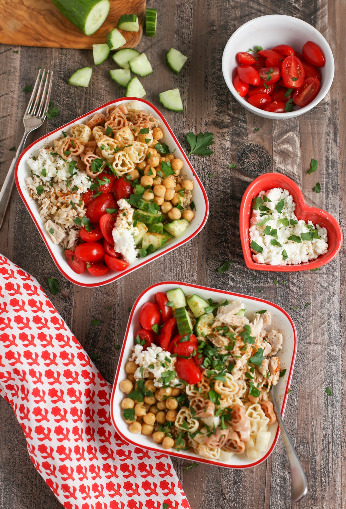 Two square bowls of Greek Pasta with ingredient display