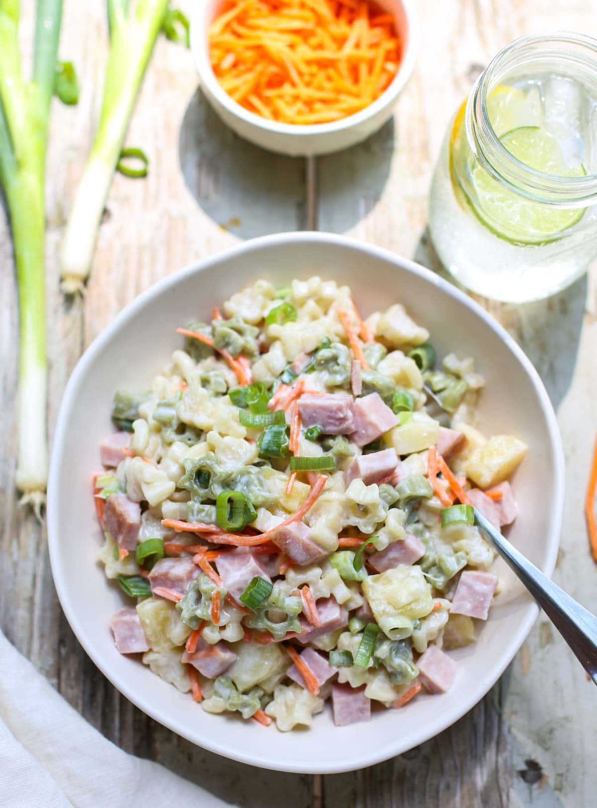 Hawaiian Pasta Salad | WorldofPastabilities | Sweet summer pasta salad combines pineapple, ham, carrots, and green onions with a deliciously fresh dressing! Perfect for a grill night or served with a summer picnic!