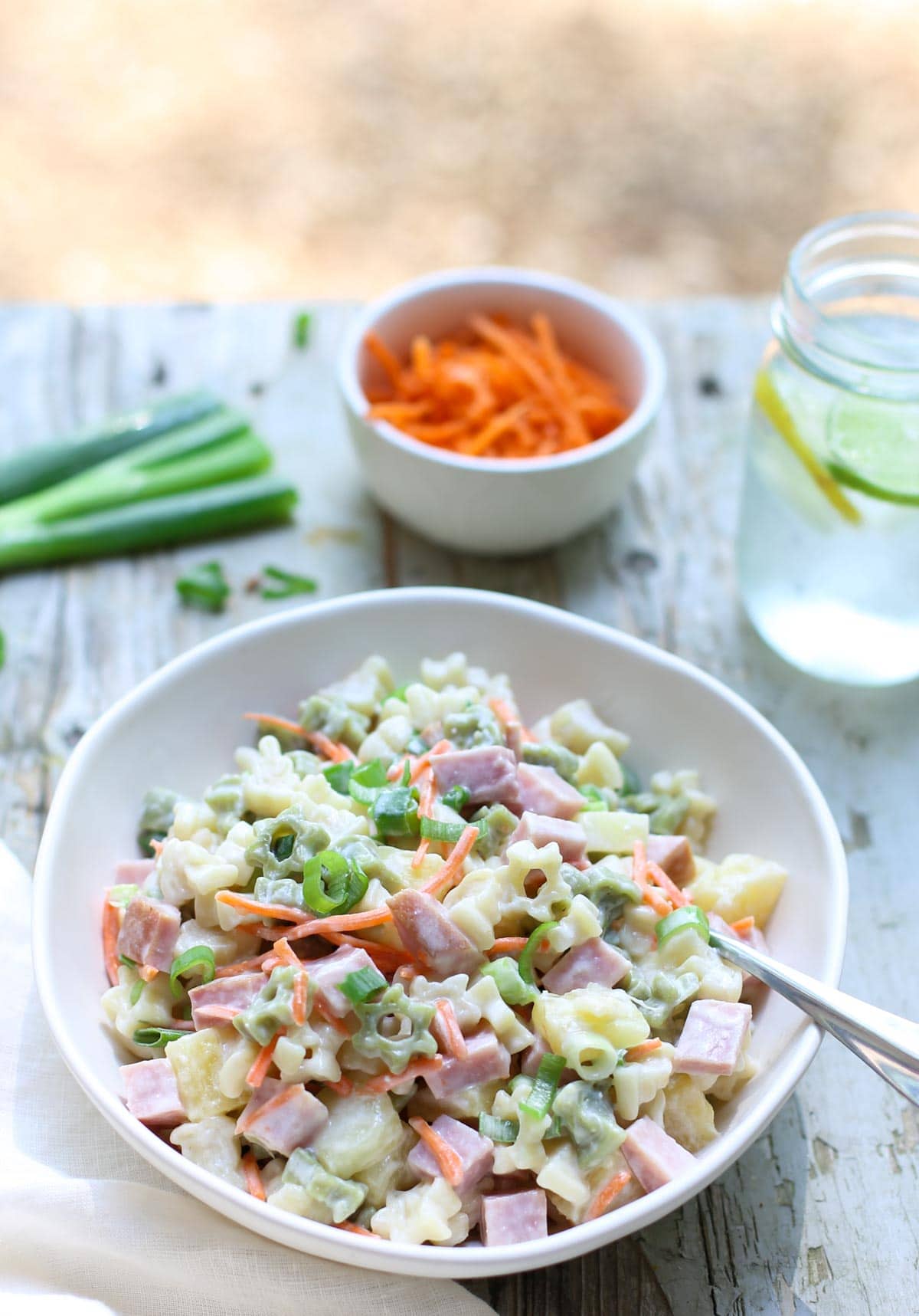 Hawaiian Pasta Salad | WorldofPastabilities | Sweet summer pasta salad combines pineapple, ham, carrots, and green onions with a deliciously fresh dressing! Perfect for a grill night or served with a summer picnic!