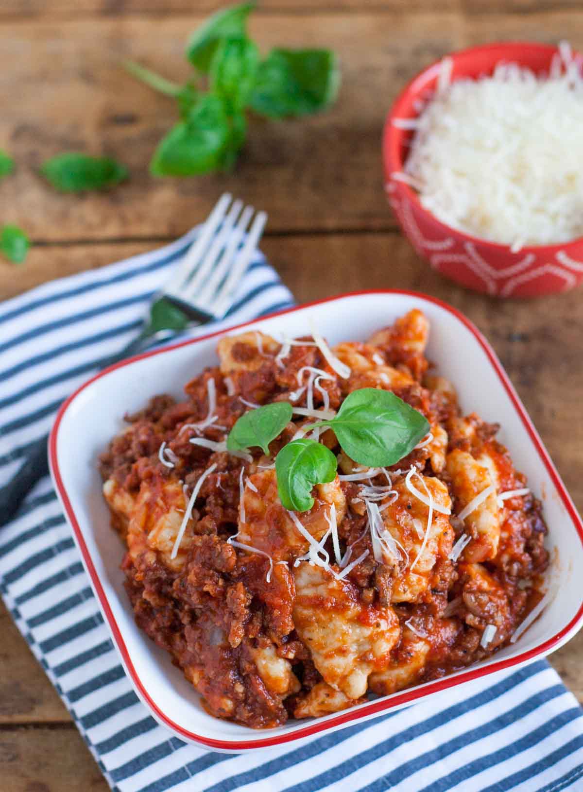 Homemade Gnocchi with Chunky Meat Sauce | WorldofPastabilities.com | Light and fluffy pillows of yumminess served with a chunky meat and sausage sauce. Easy to make - no special equipment needed!