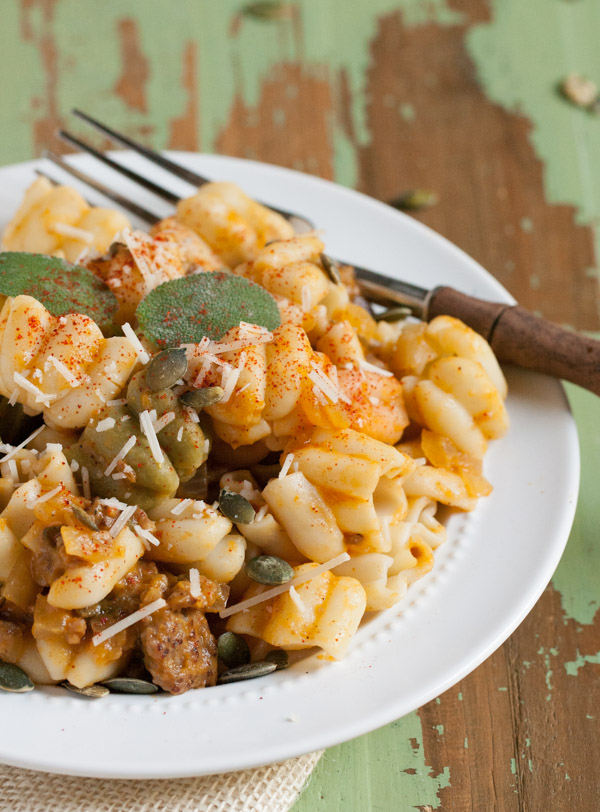 Italian Sausage and Pumpkin Pasta combines delicious fall flavors and textures. Pumpkin, Italian sausage, coconut milk, and spices create a hearty yet light pasta! Your tastebuds will love it! | WorldofPastabilities.com