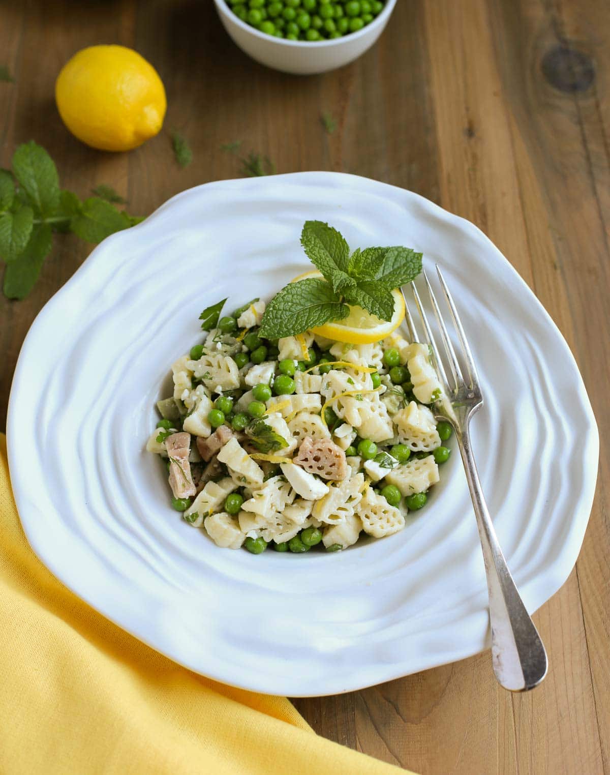 Light and Herby Mediterranean Pasta Salad | Lemon, Feta, and Fresh Chopped Herbs make this a light and delicious side dish! A tangy vinaigrette dressing ties it all together...yum! Great with any grilled meats or seafood! | WorldofPastabilities.com