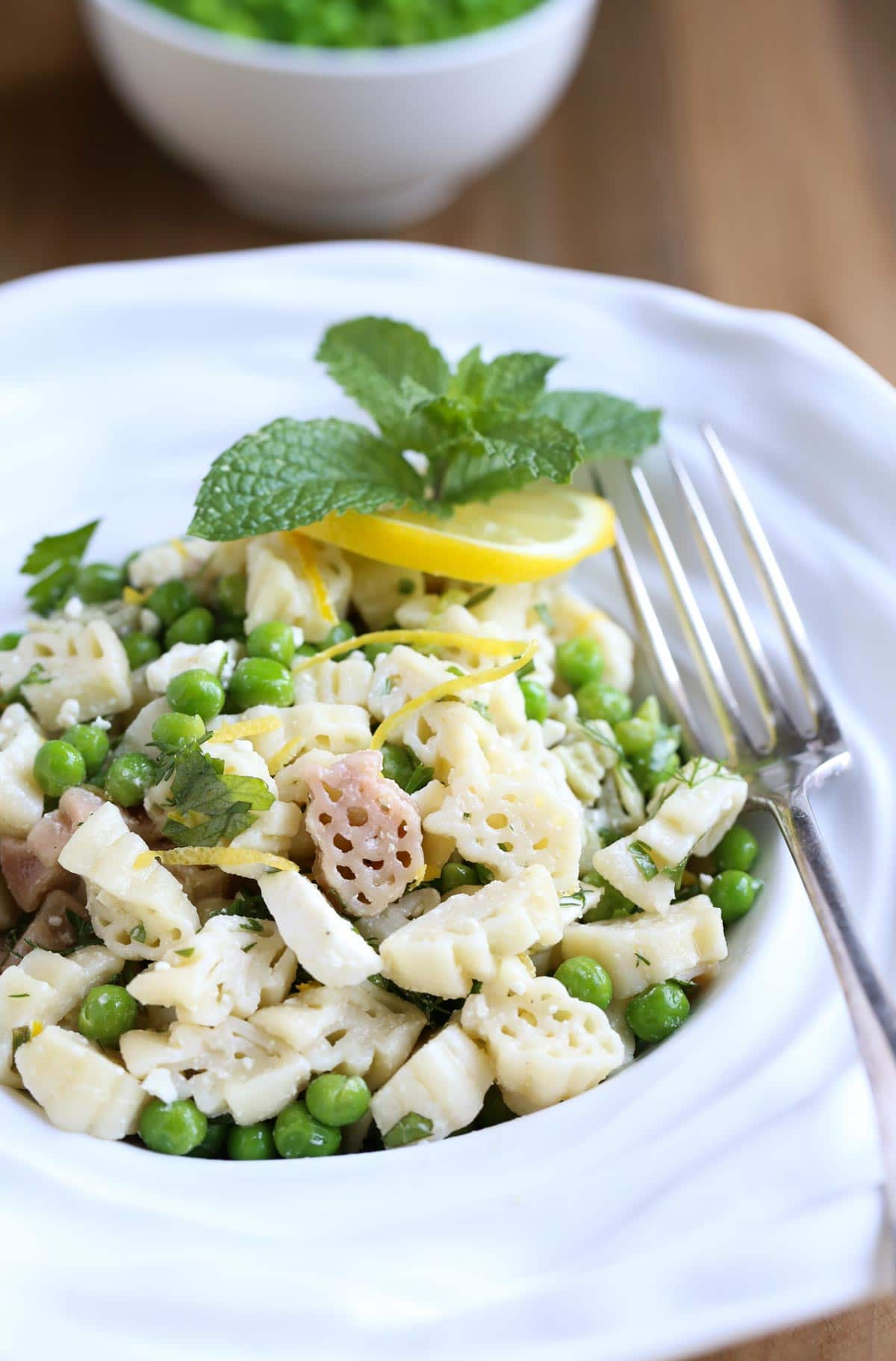 Light and Herby Mediterranean Pasta Salad | Lemon, Feta, and Fresh Chopped Herbs make this a light and delicious side dish! A tangy vinaigrette dressing ties it all together...yum! Great with any grilled meats or seafood! | WorldofPastabilities.com