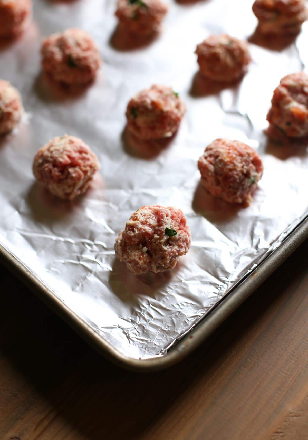 Mini Ricotta Meatballs with Herbed Tomato Suace| WorldofPastabilities.com | Moist, delicious, super simple recipe that they entire family will LOVE! Easy to freeze for later too!