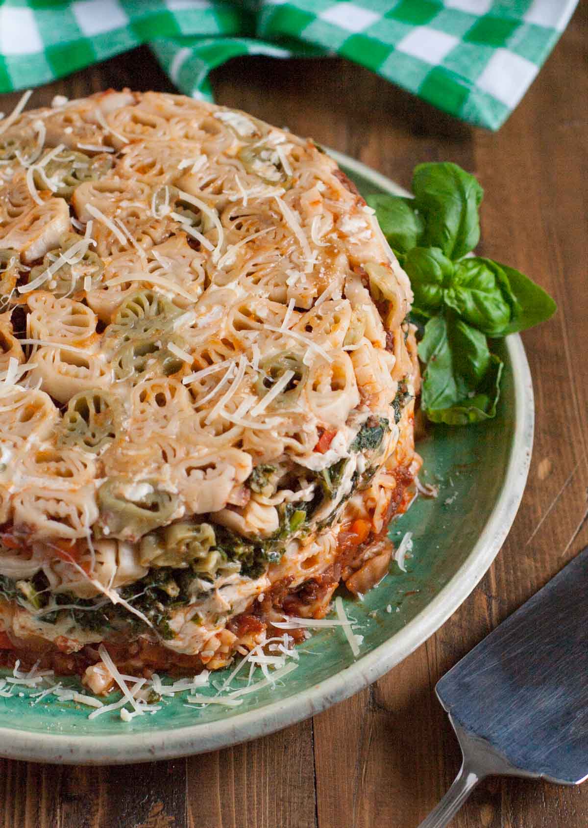 Tailgate Timballo | WorldofPastabilities.com | Nine layers of fabulous flavors: meat sauce, kale bechamel, fresh cheeses, and pasta. Serve slices during the big games and WOW your guests! Fun with any shaped pasta!