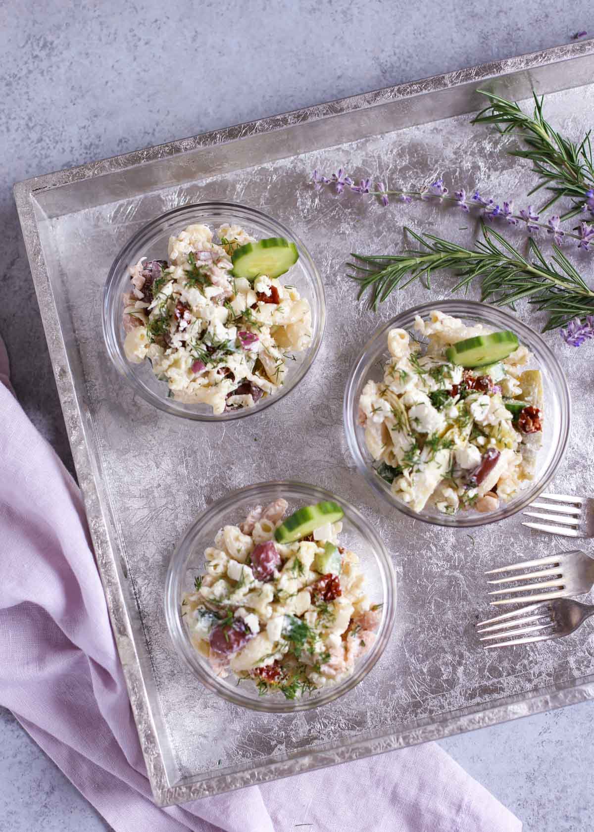 Tzatziki Pasta Salad | Cool and tangy Tzatziki Pasta Salad is the perfect side for a hot summer night! Artichokes, sun dried tomatoes, Kalamata olives, and crunchy cucumbers add just the right Greek flavors. Yum! Serve with grilled meats or chicken! Enjoy! | WorldofPastabilities.com