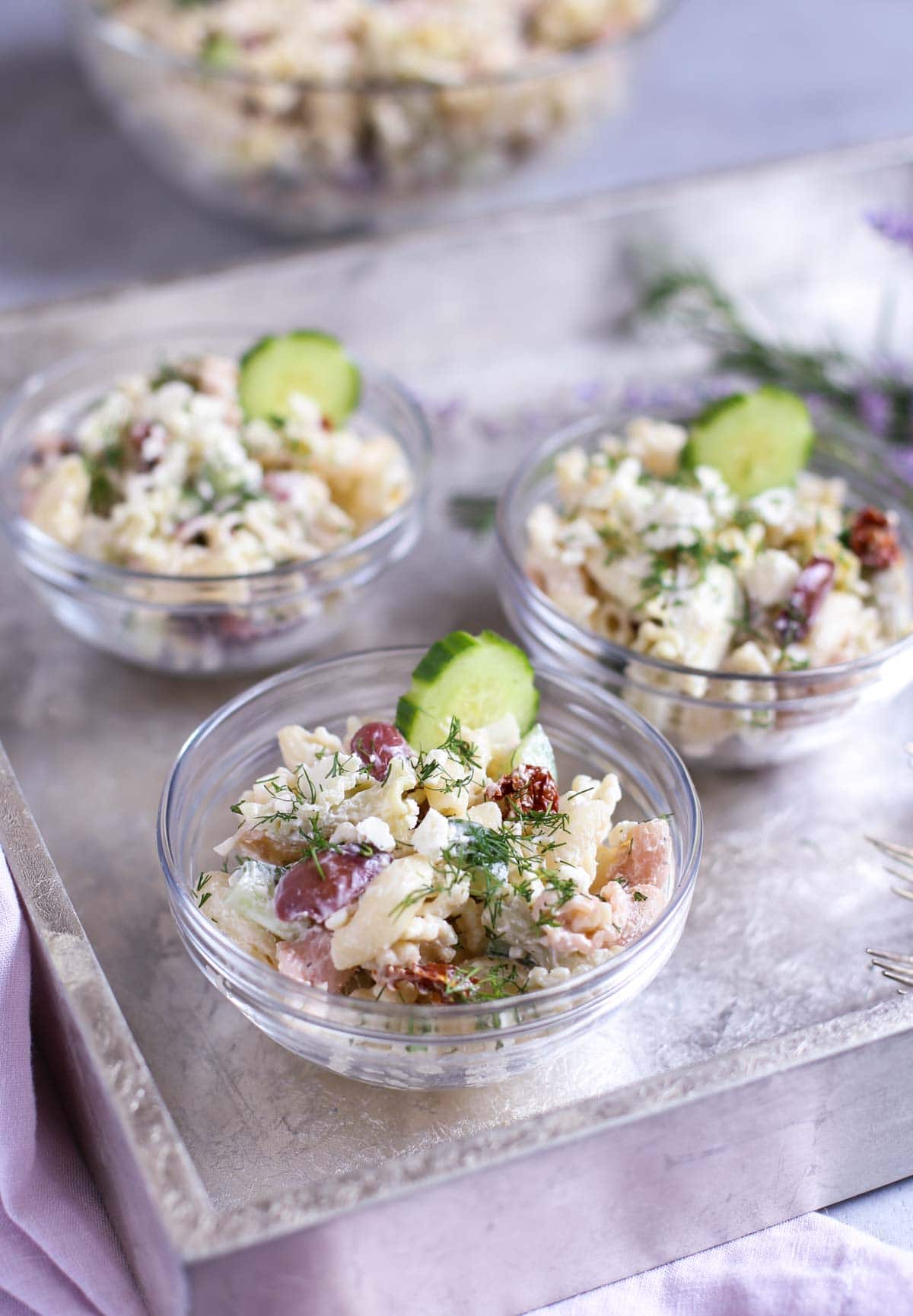 Tzatziki Pasta Salad | Cool and tangy Tzatziki Pasta Salad is the perfect side for a hot summer night! Artichokes, sun dried tomatoes, Kalamata olives, and crunchy cucumbers add just the right Greek flavors. Yum! Serve with grilled meats or chicken! Enjoy! | WorldofPastabilities.com