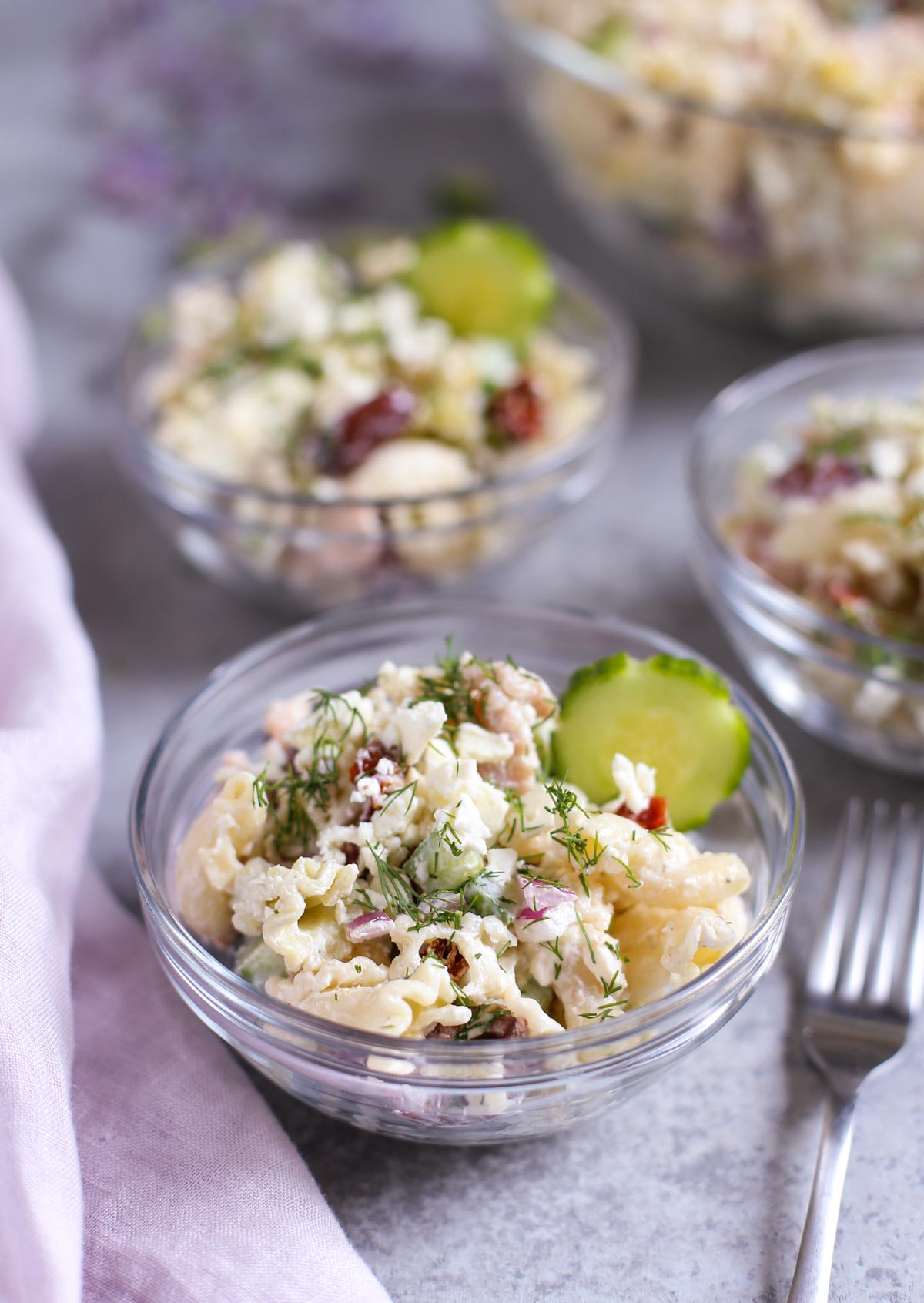 Tzatziki Pasta Salad | Cool and tangy Tzatziki Pasta Salad is the perfect side for a hot summer night! Artichokes, sun dried tomatoes, Kalamata olives, and crunchy cucumbers add just the right Greek flavors. Yum! Serve with grilled meats or chicken! Enjoy! | WorldofPastabilities.com