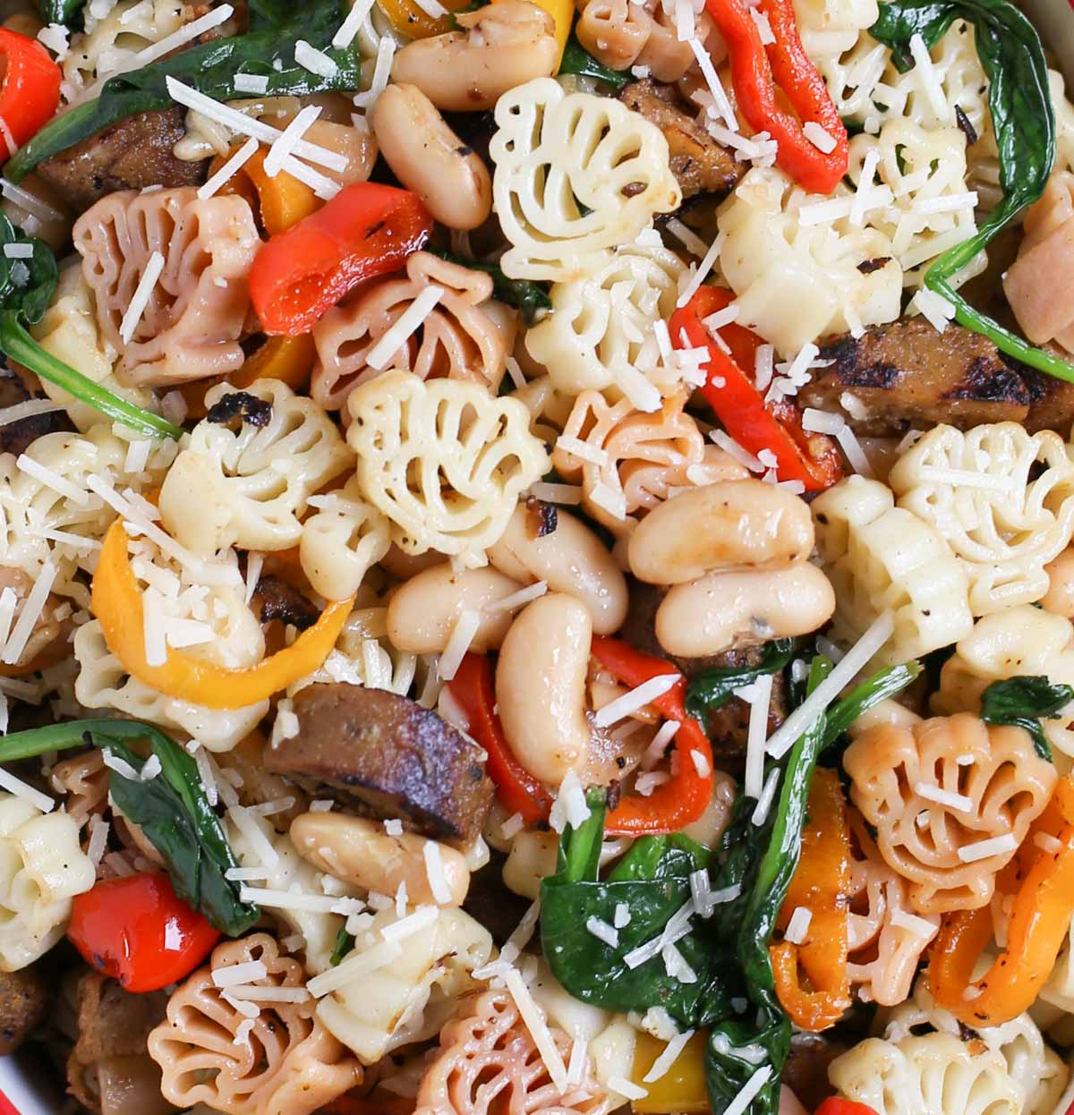 Veggie Sausage and Sweet Peppers with Turkey Pasta - a Thanksgiving Alternative! | Vegan Sausage, onions, colorful sweet peppers, fresh spinach and cannellini beans combine to make a delicious and hearty dish! | Add something new to your menu! | WorldofPastabilities.com