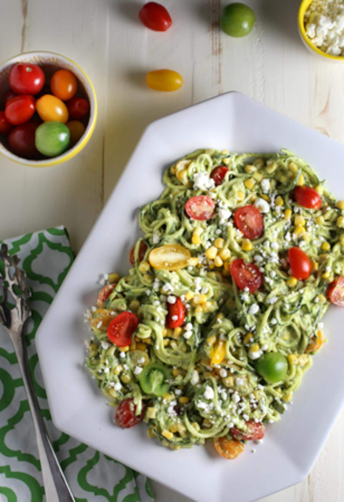 Zucchini Noodle Salad with Tomatoes, Goat Cheese, Corn & Avocado Sauce | WorldofPastabilities.com | Healthy, fresh, and delicious noodles that will convince even the kids it is pasta! The avocado sauce is the star...perfect side for any grilled meats this spring and summer!