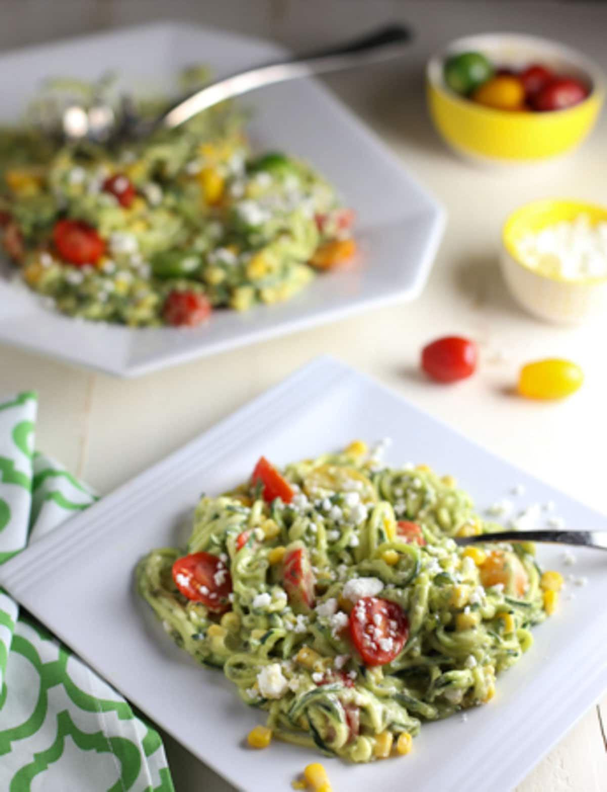 Zucchini Noodle Salad with Tomatoes, Goat Cheese, Corn & Avocado Sauce | WorldofPastabilities.com | Healthy, fresh, and delicious noodles that will convince even the kids it is pasta! The avocado sauce is the star...perfect side for any grilled meats this spring and summer!