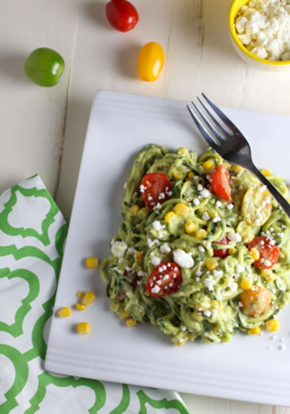 Zucchini Noodle Salad with Tomatoes, Goat Cheese, Corn & Avocado Sauce | WorldofPastabilities.com | Healthy, fresh, and delicious noodles that will convince even the kids it is pasta! The avocado sauce is the star...perfect side for any grilled meats this spring and summer!